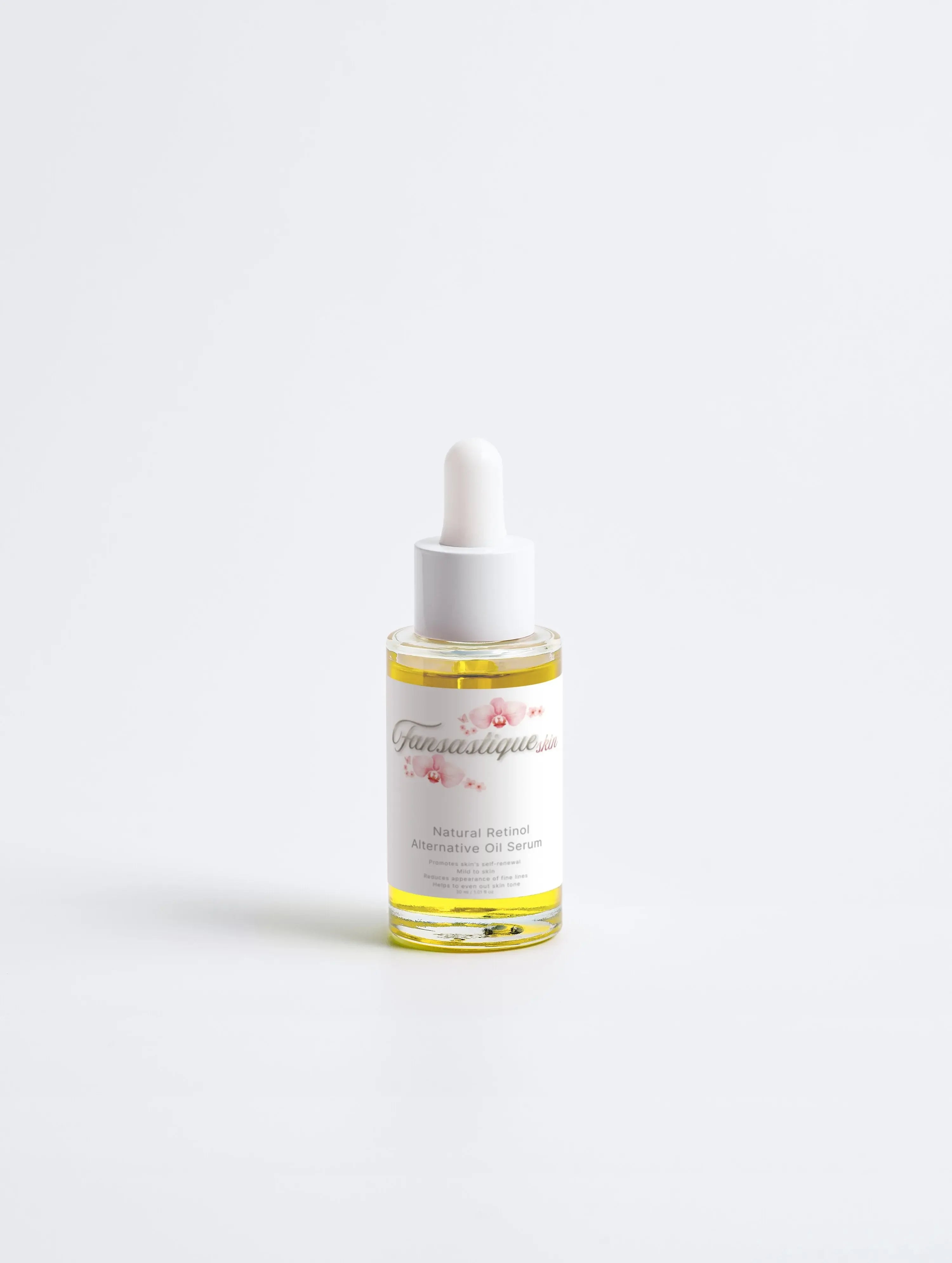 Glazen flesje met gezichtsolie serum, pipetdop, tegen witte achtergrond, skincare product